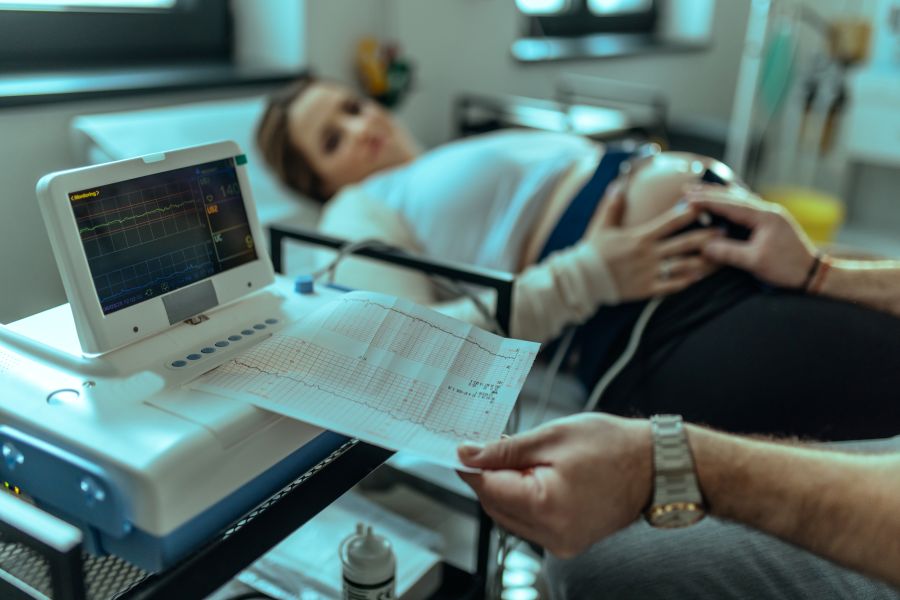 A pregnant woman visiting a gynecologist for an examination