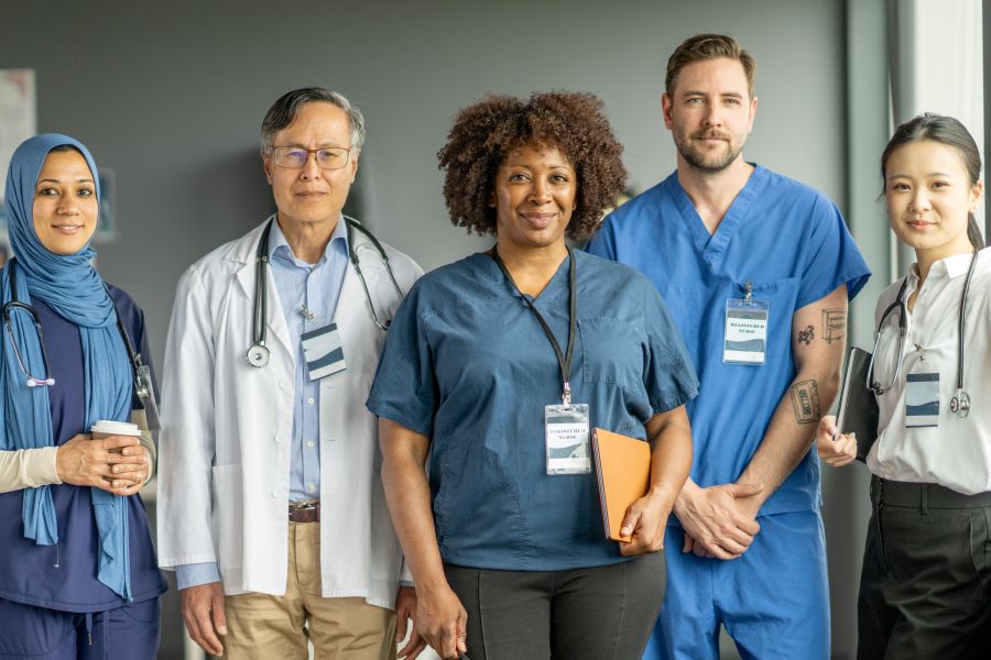 Diverse Healthcare Team Standing Together in a Medical Setting - stock photo