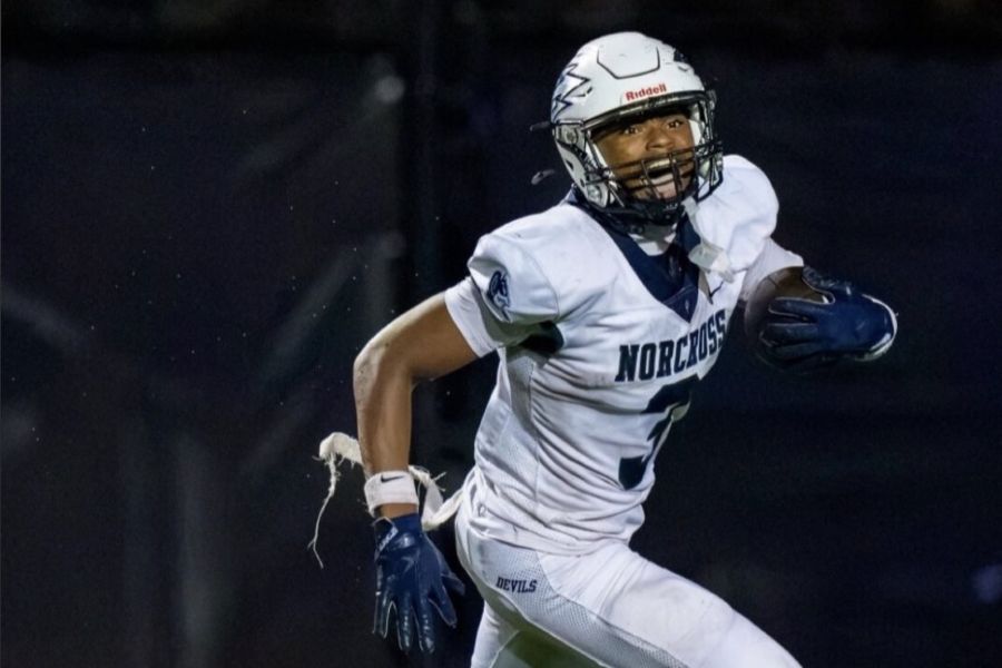 Photo of Tommie running in a football game